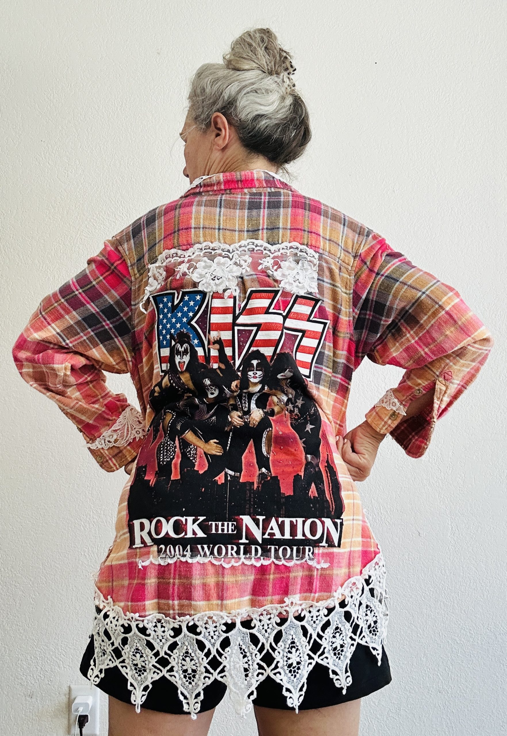 Upcycled KISS band flannel featuring 2004 Rock the Nation World Tour graphic, vibrant pink hand-bleached ombré, and wide ornate white lace hem.