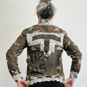 Upcycled U2 camo utility jacket with Vertigo 05 tour graphics, a lace-overlaid "Dismantle" back patch, and vintage lace trim on the hem and cuffs.
