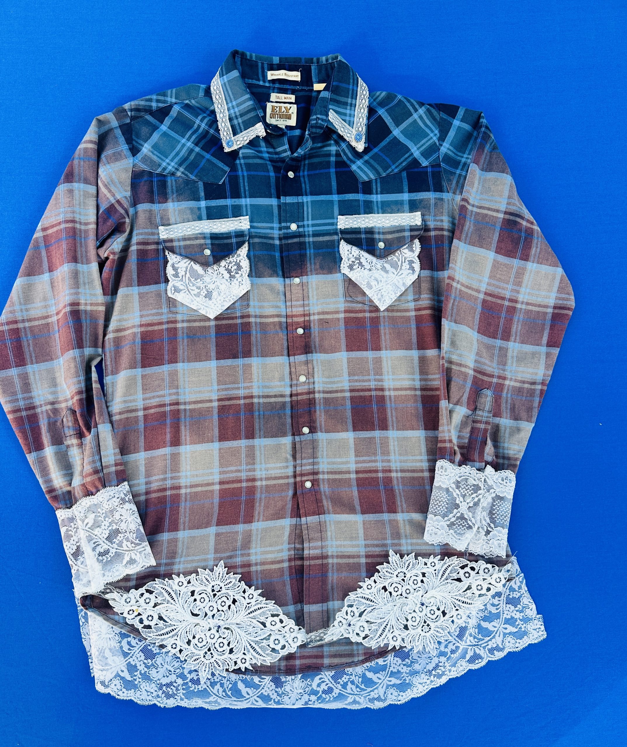 Upcycled Velvet Revolver flannel shirt with teal and blue bleached ombré, vintage white lace cuffs and hem, and a rock band back patch.